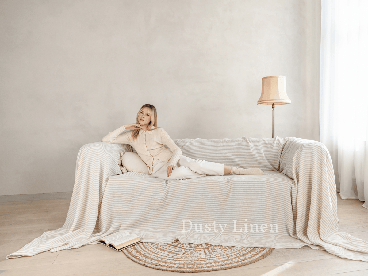Linen couch cover draped on sofa, loose fit natural tone, custom size