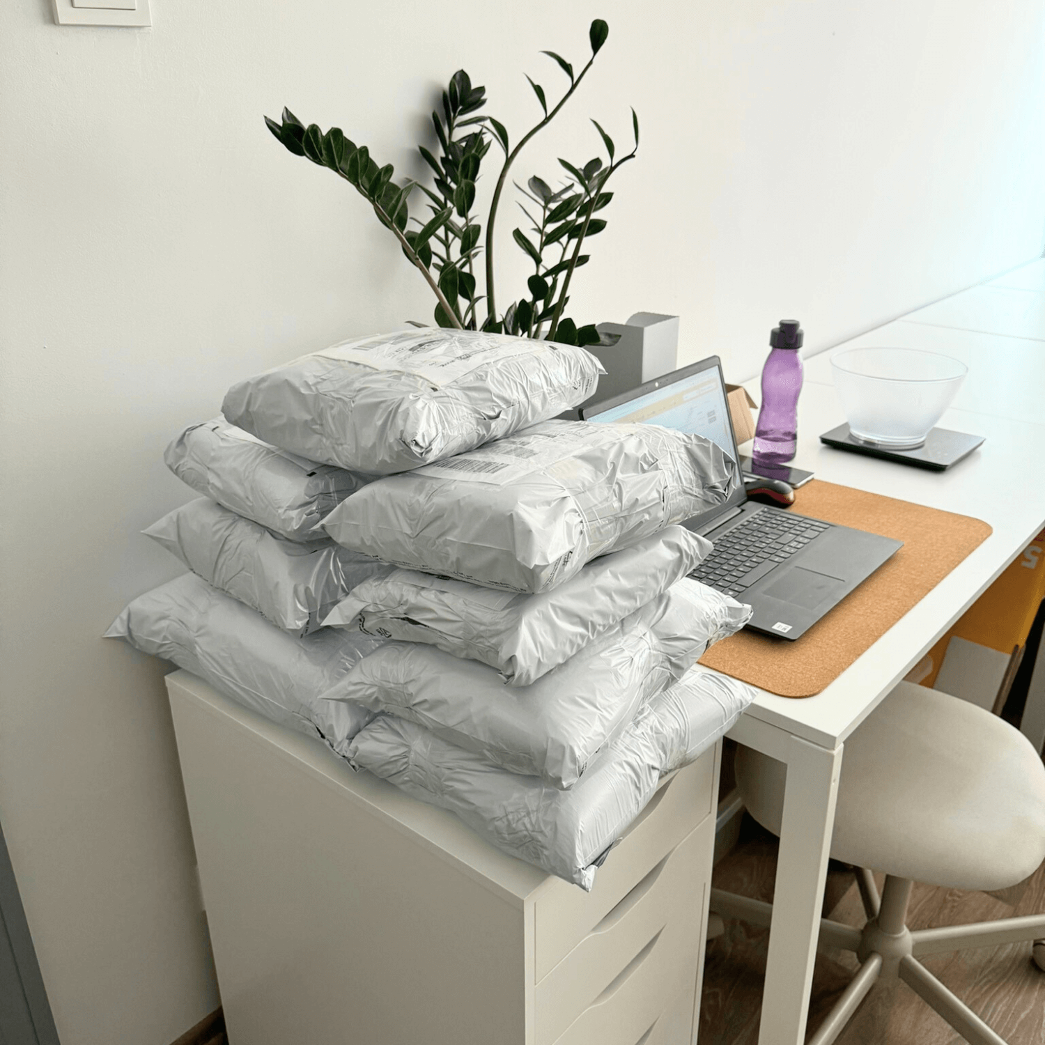 Folded linen textile orders stacked on a workshop table