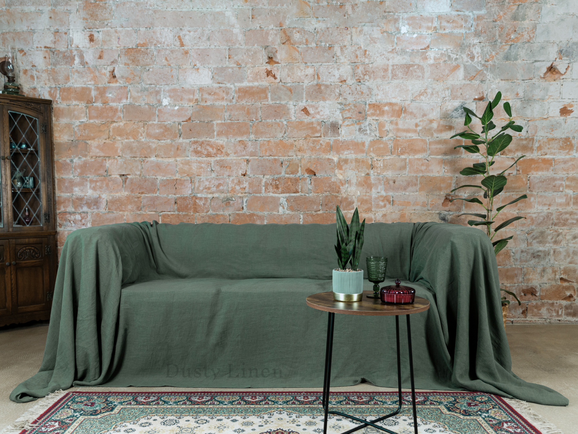 a living room with a couch covered in a green cover