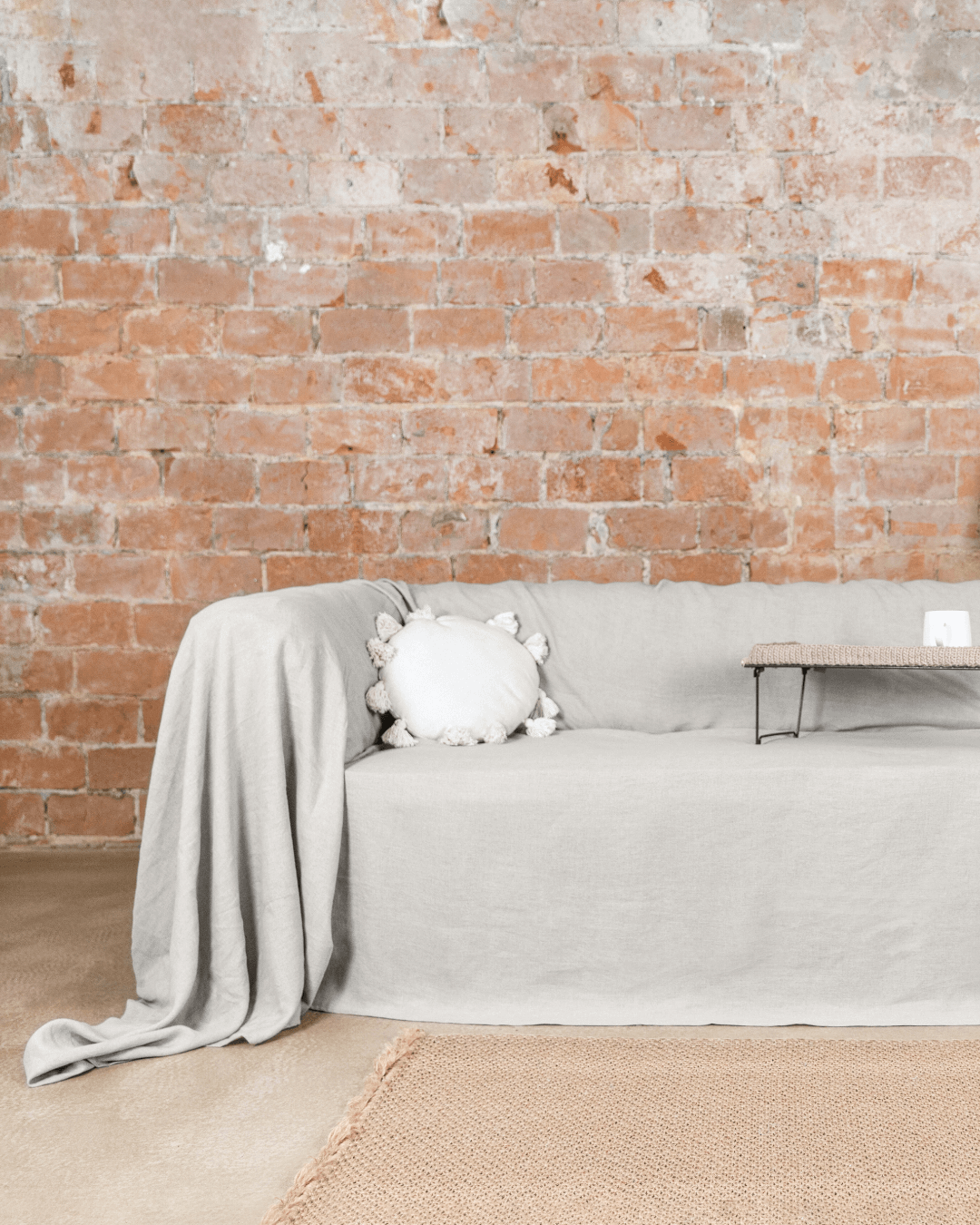 a living room with a couch covered in a blanket