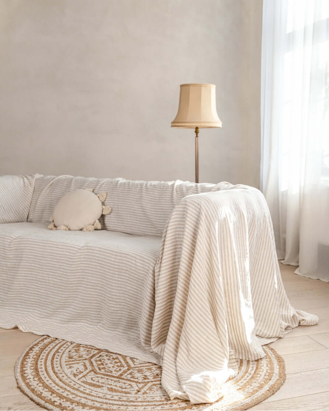 a living room with a couch covered in a blanket