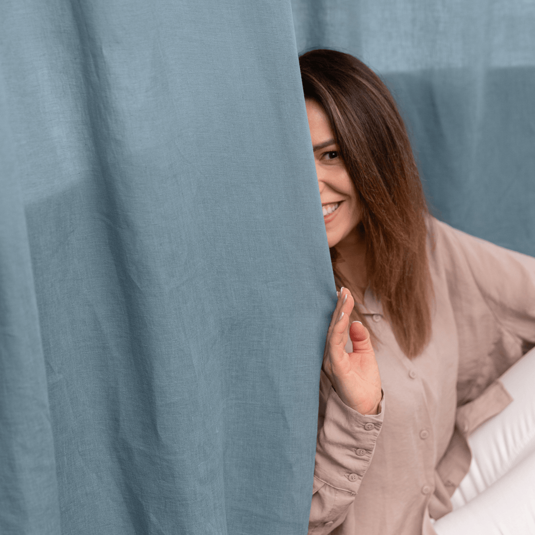 Woman holding soft linen bedding, premium European linen texture close-up
