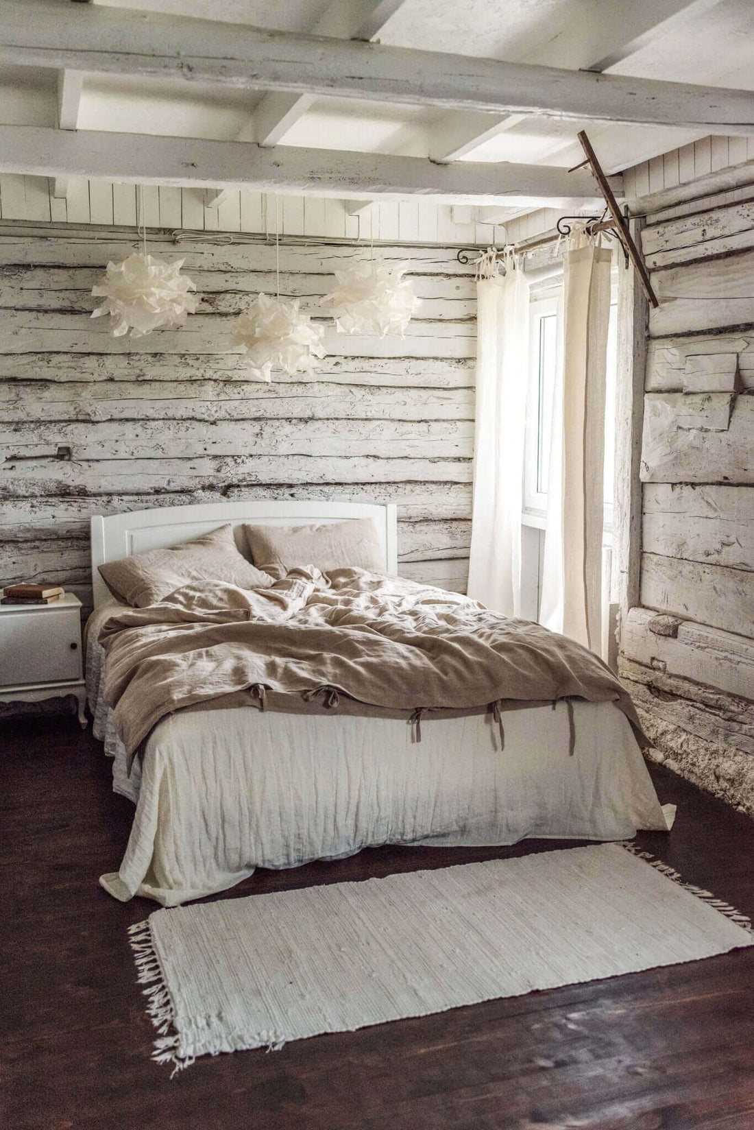 Natural linen curtains and bedding in a bright minimalist home interior