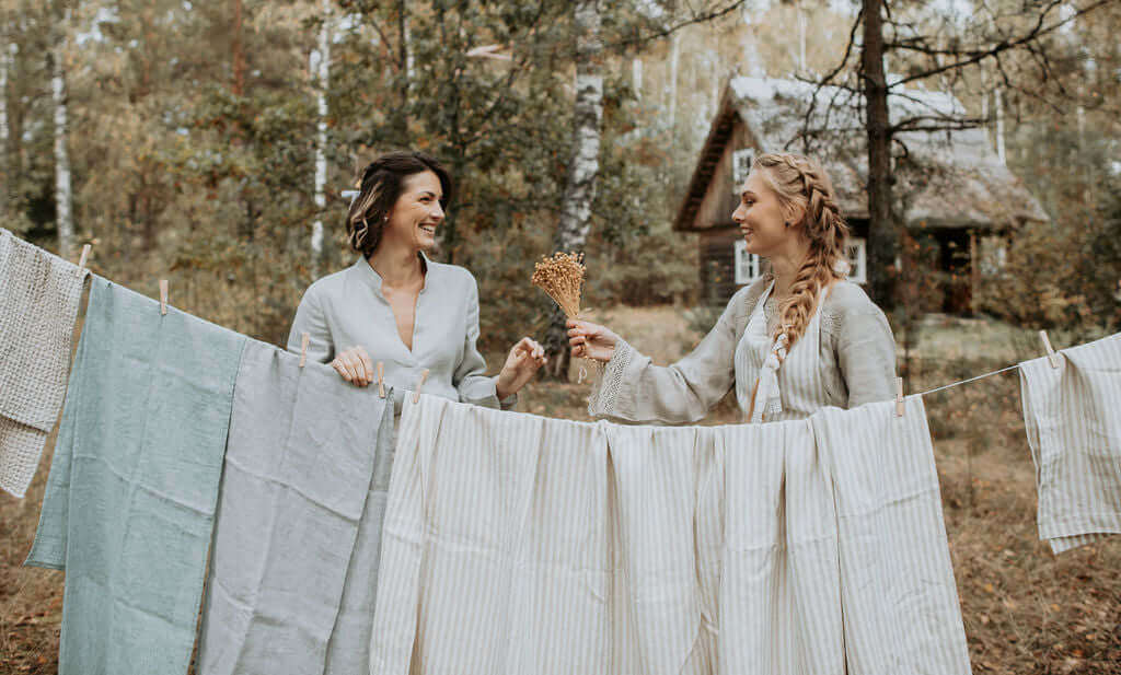 Row of white linen garments and home textiles, sustainable future of linen