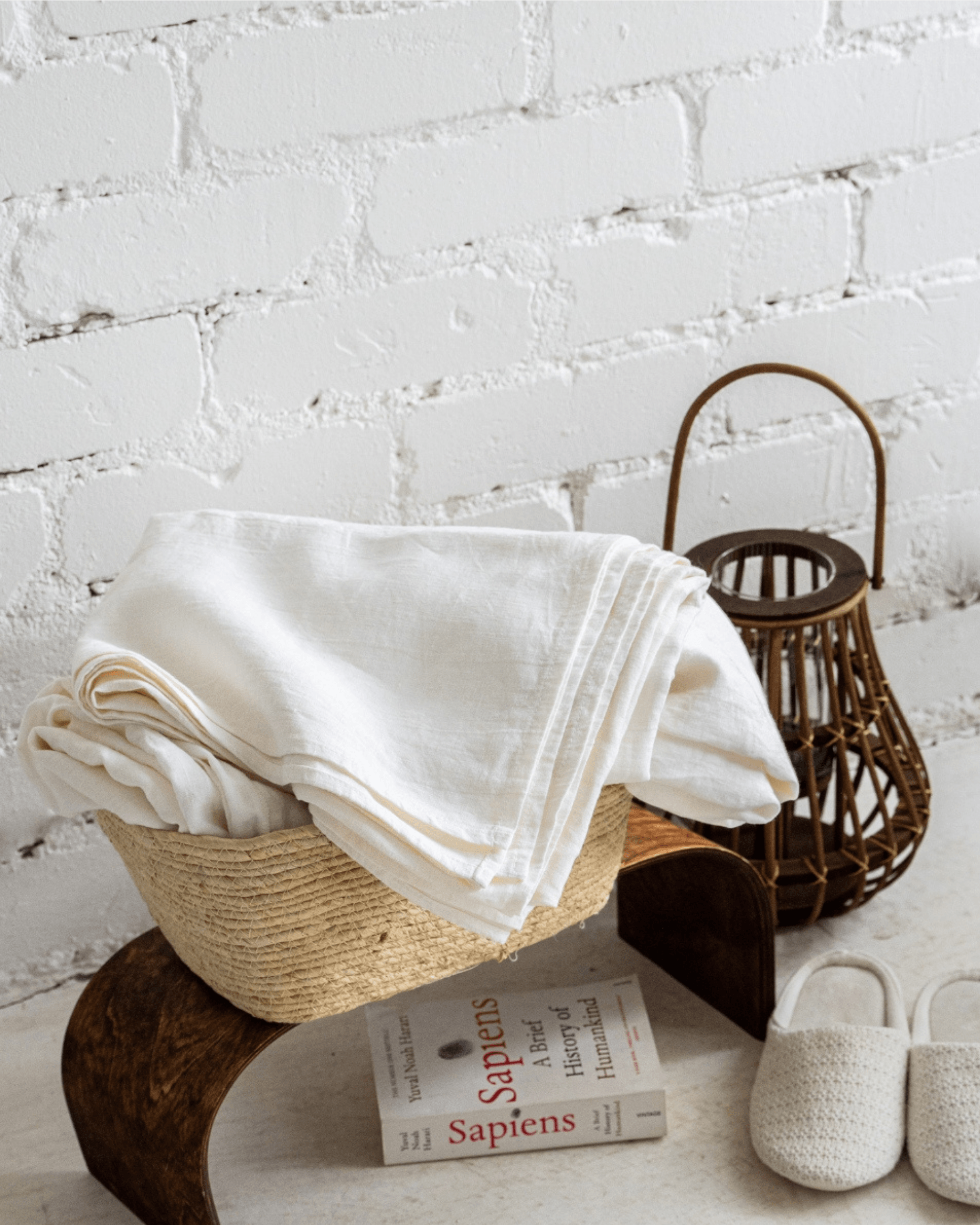 Linen flat sheet folded and stacked on wooden bench
