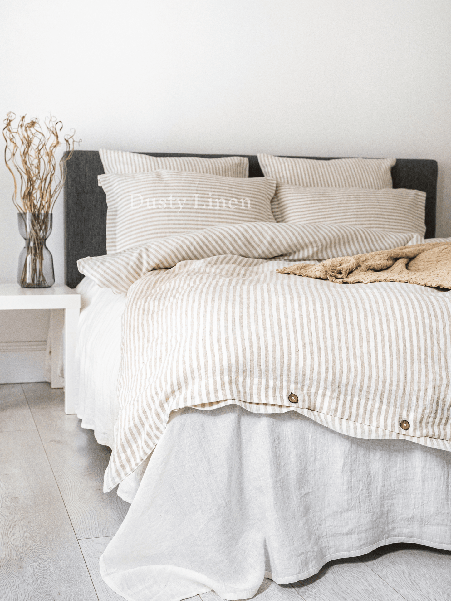 a bed with a white and black striped comforter