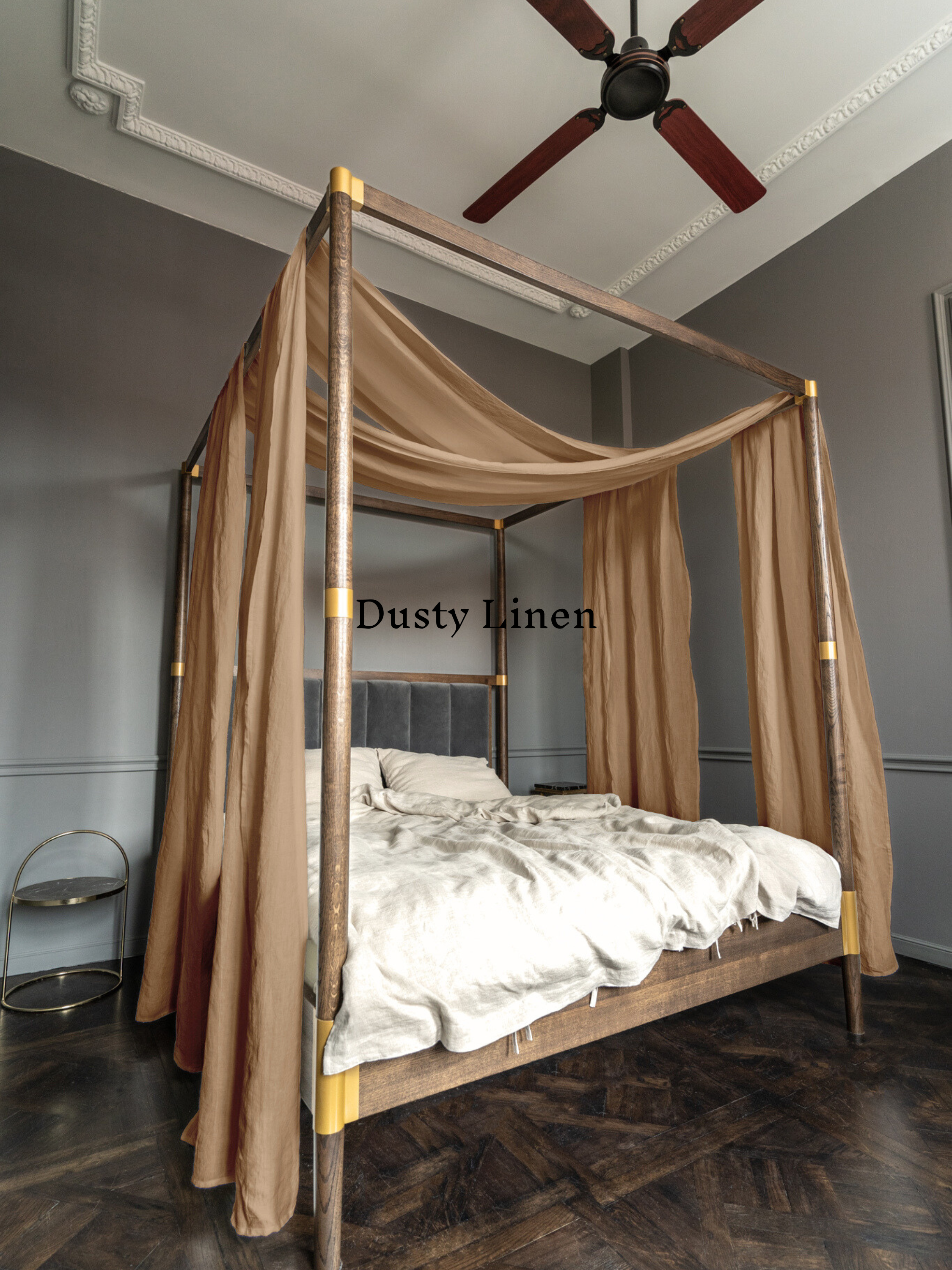 a bed with a canopy in a room with a ceiling fan