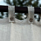 a close up of a curtain with a tree in the background