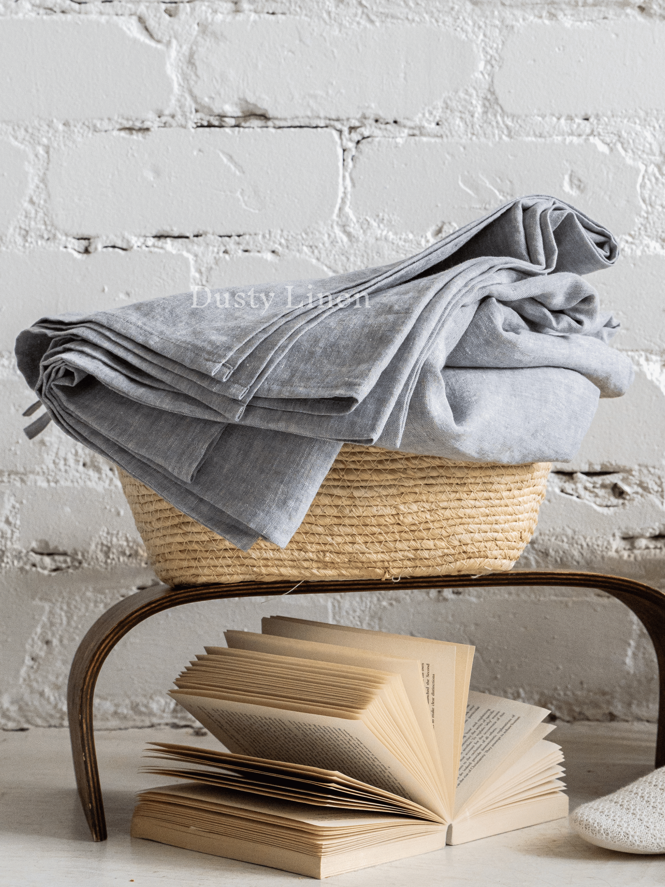 a stack of books sitting on top of a table next to a basket