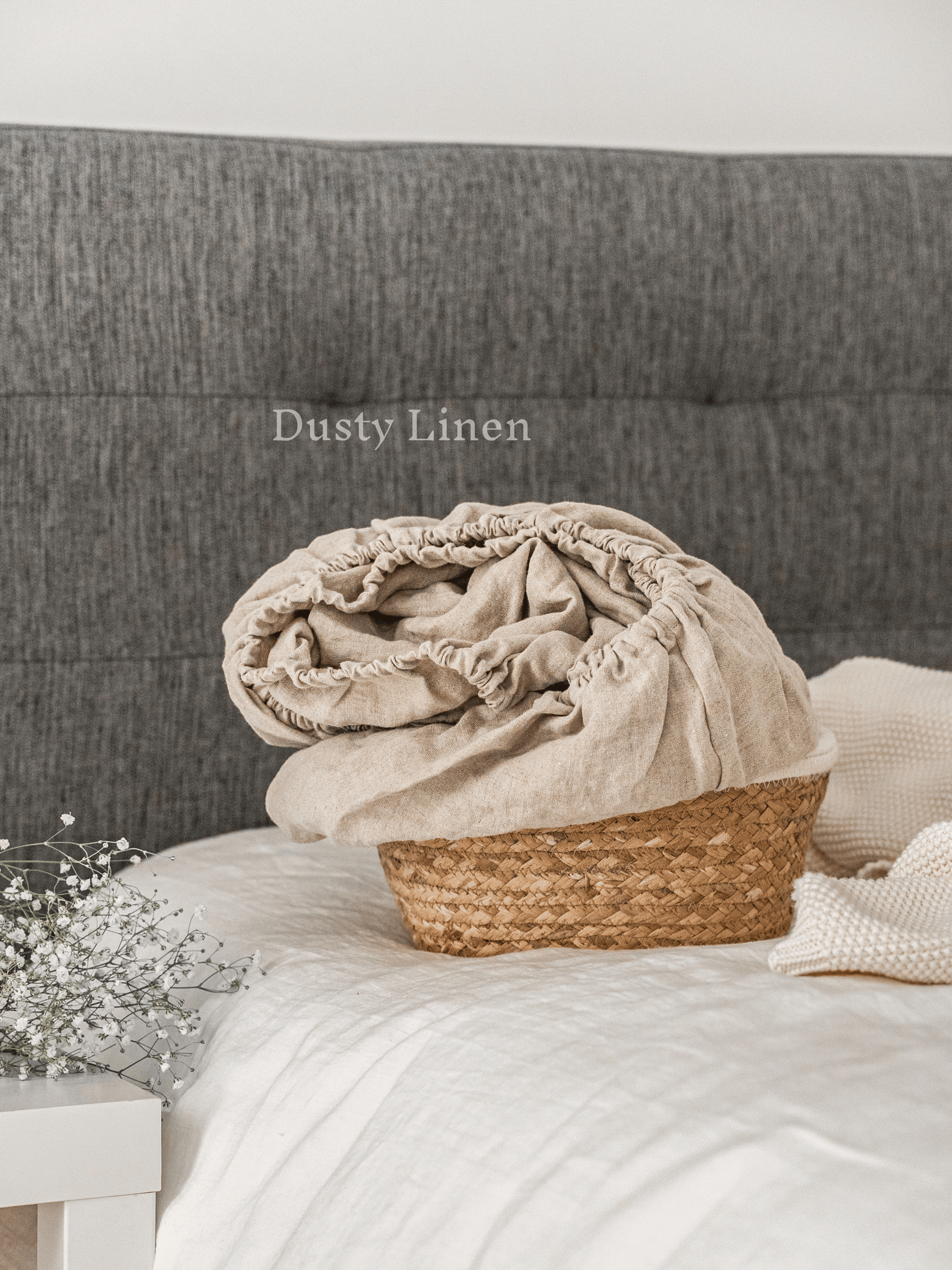 a basket with a blanket on top of a bed