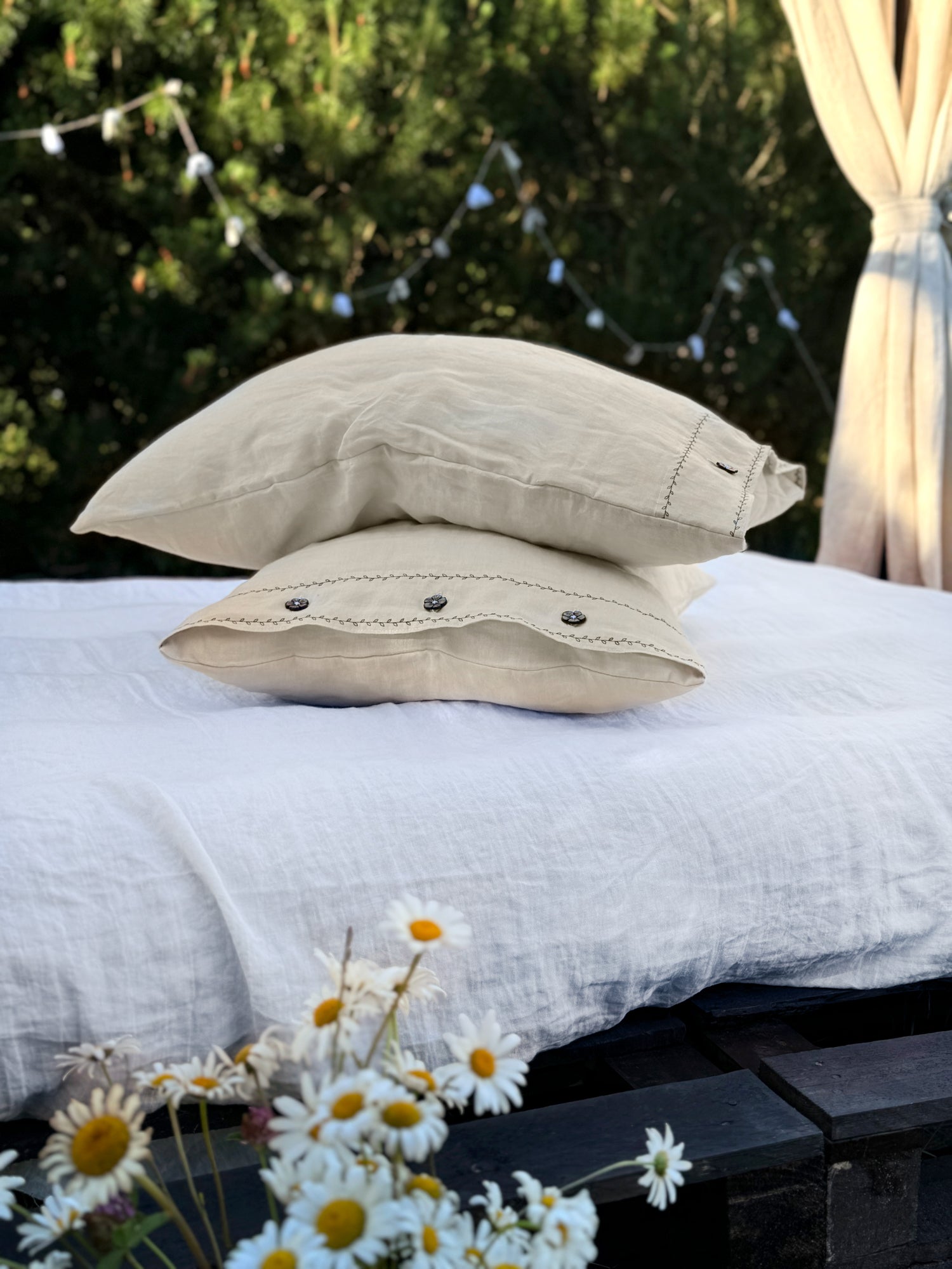 two pillows on top of a white bed