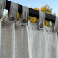 a close up of a curtain with buttons on it