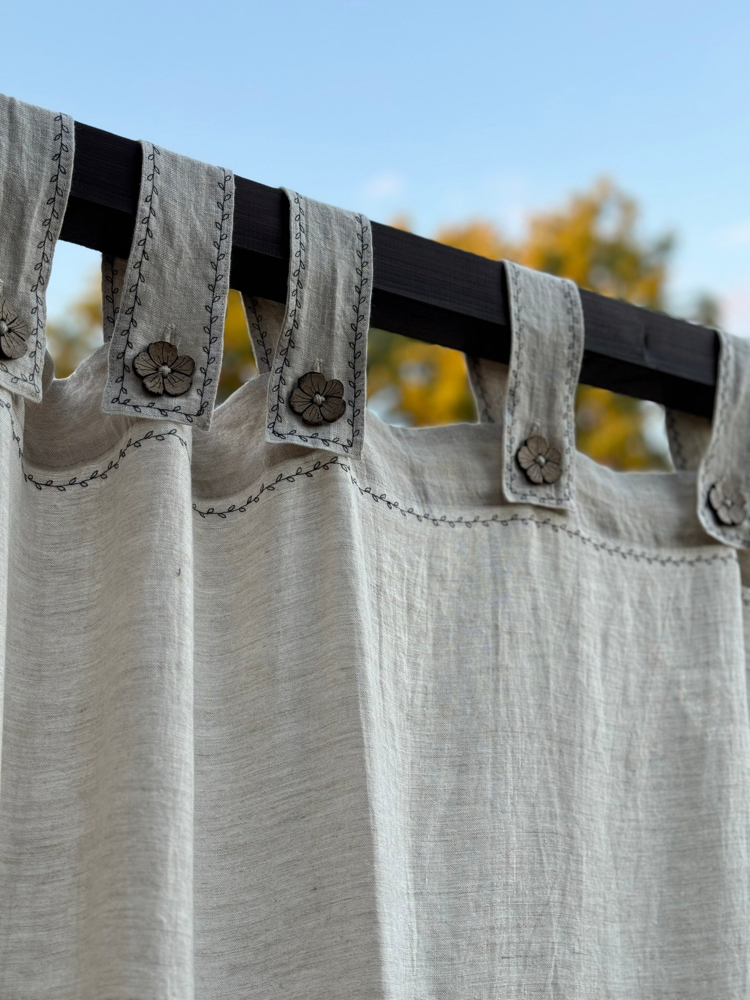 a close up of a curtain with buttons on it