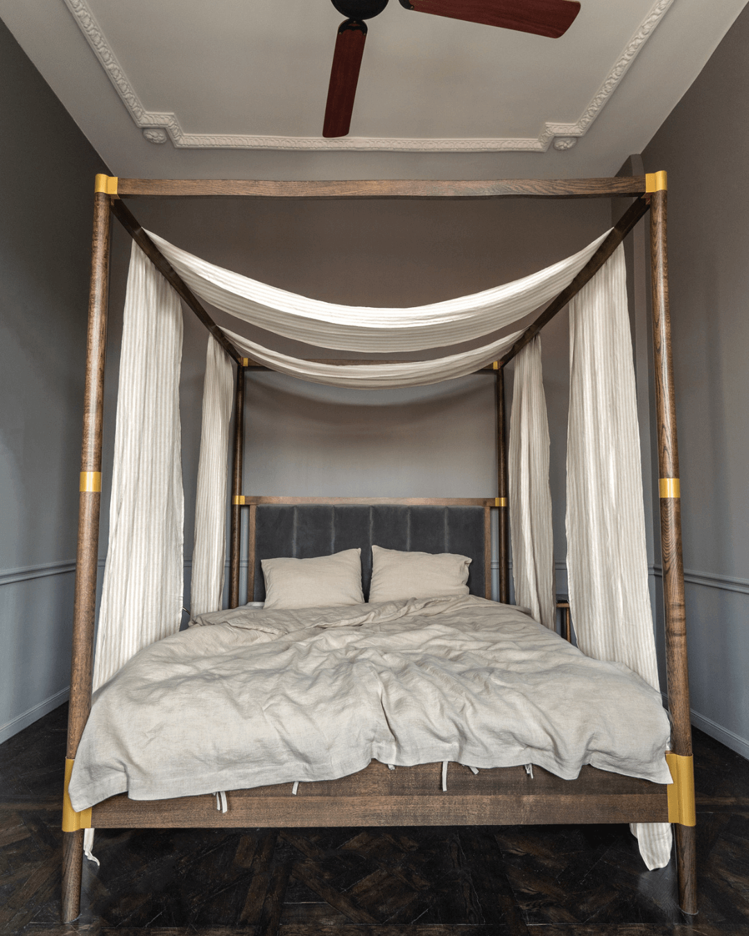 a bed with a white canopy and white sheets