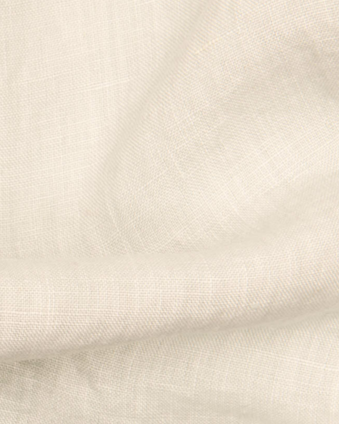 a close up of a white cloth with a black dot on it