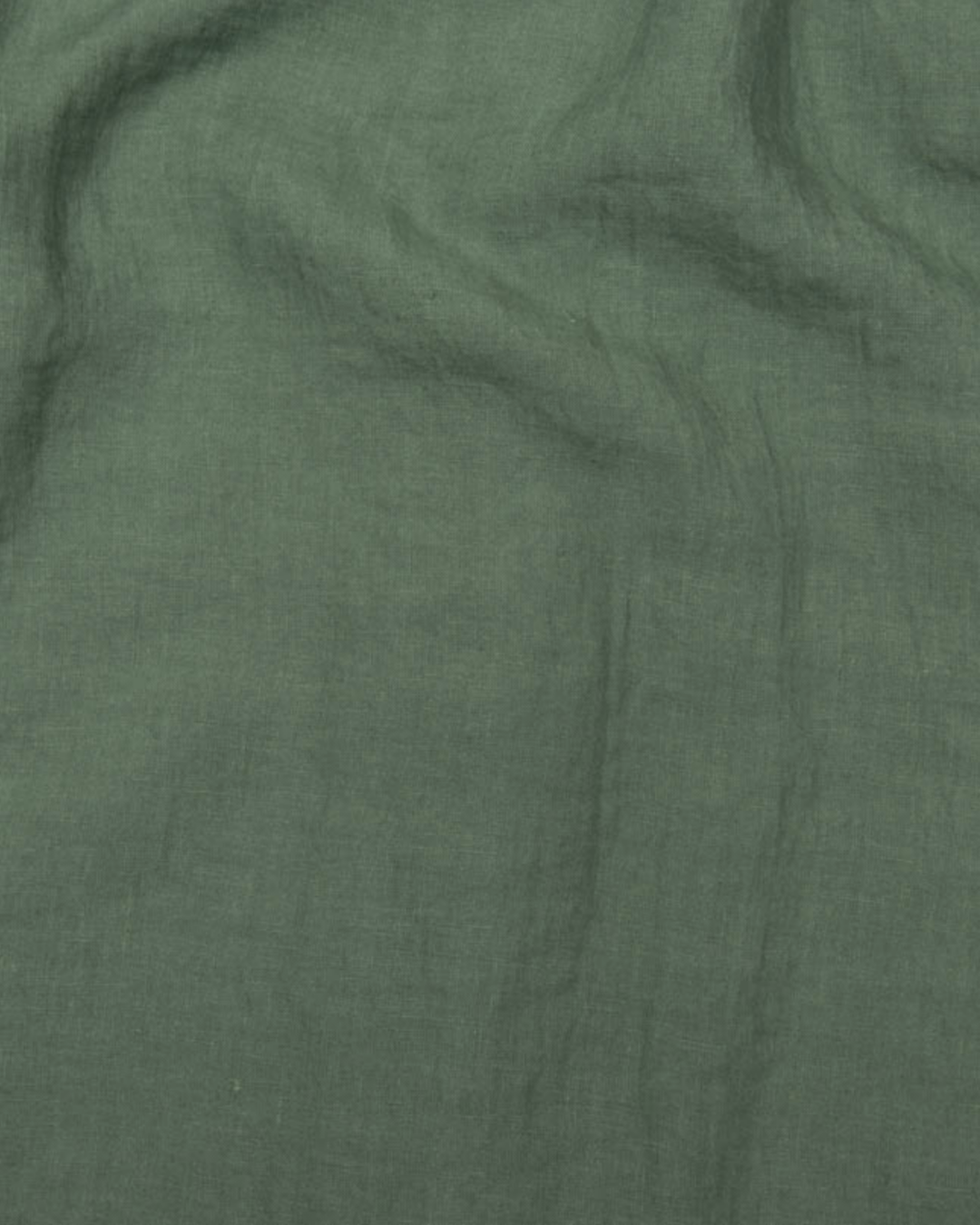 a close up of a green cloth with a black dot on it