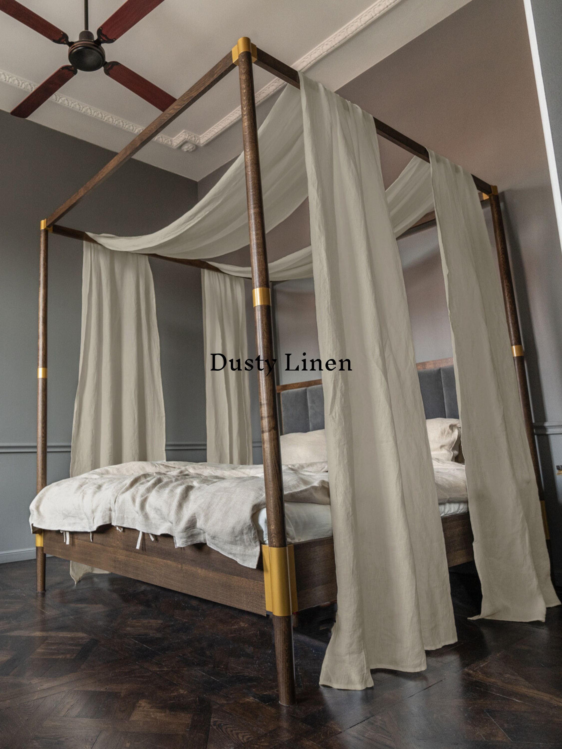 a four poster bed with a white canopy