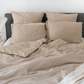 a bed that has some pillows on it