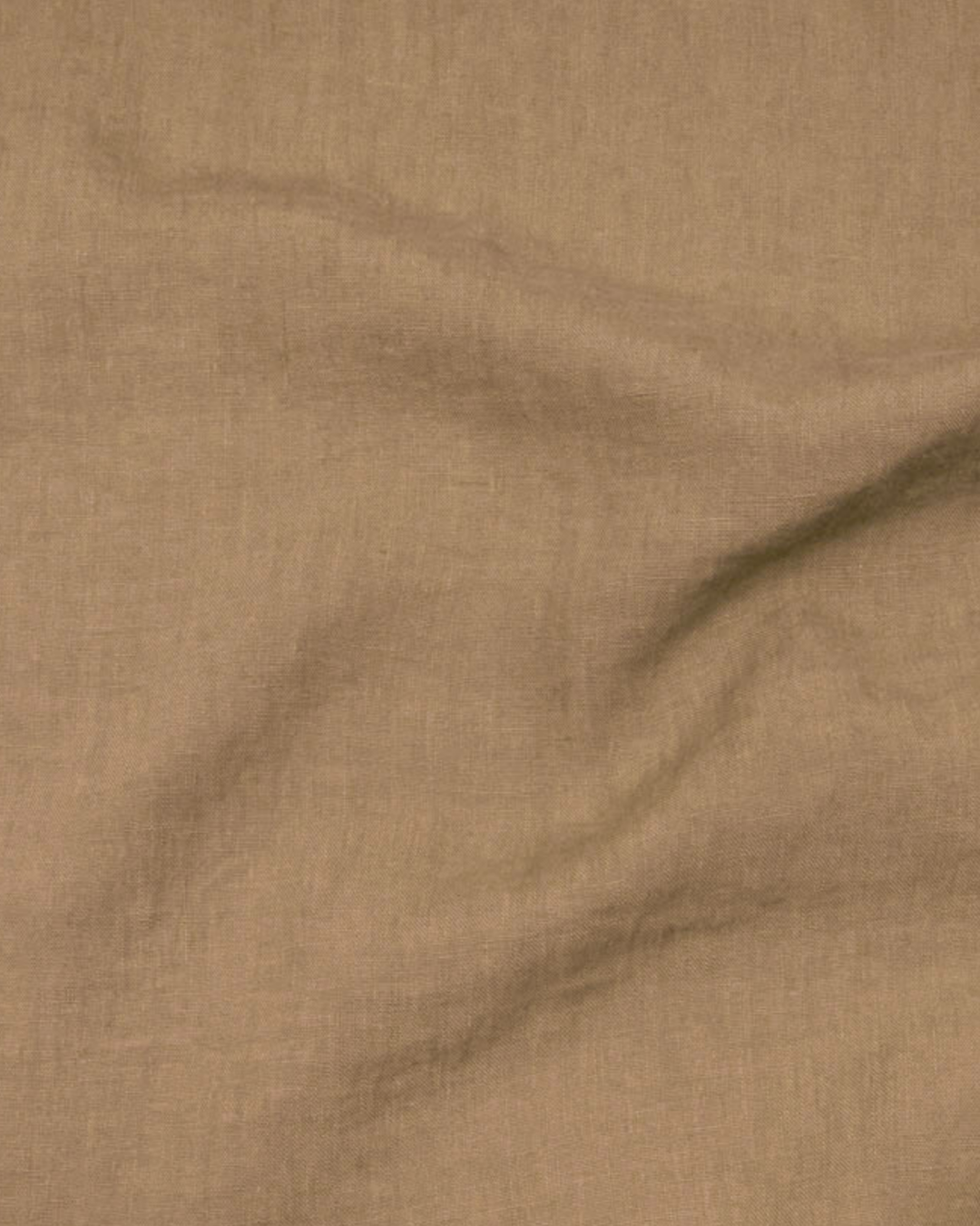 a brown sheet with a black dot on it