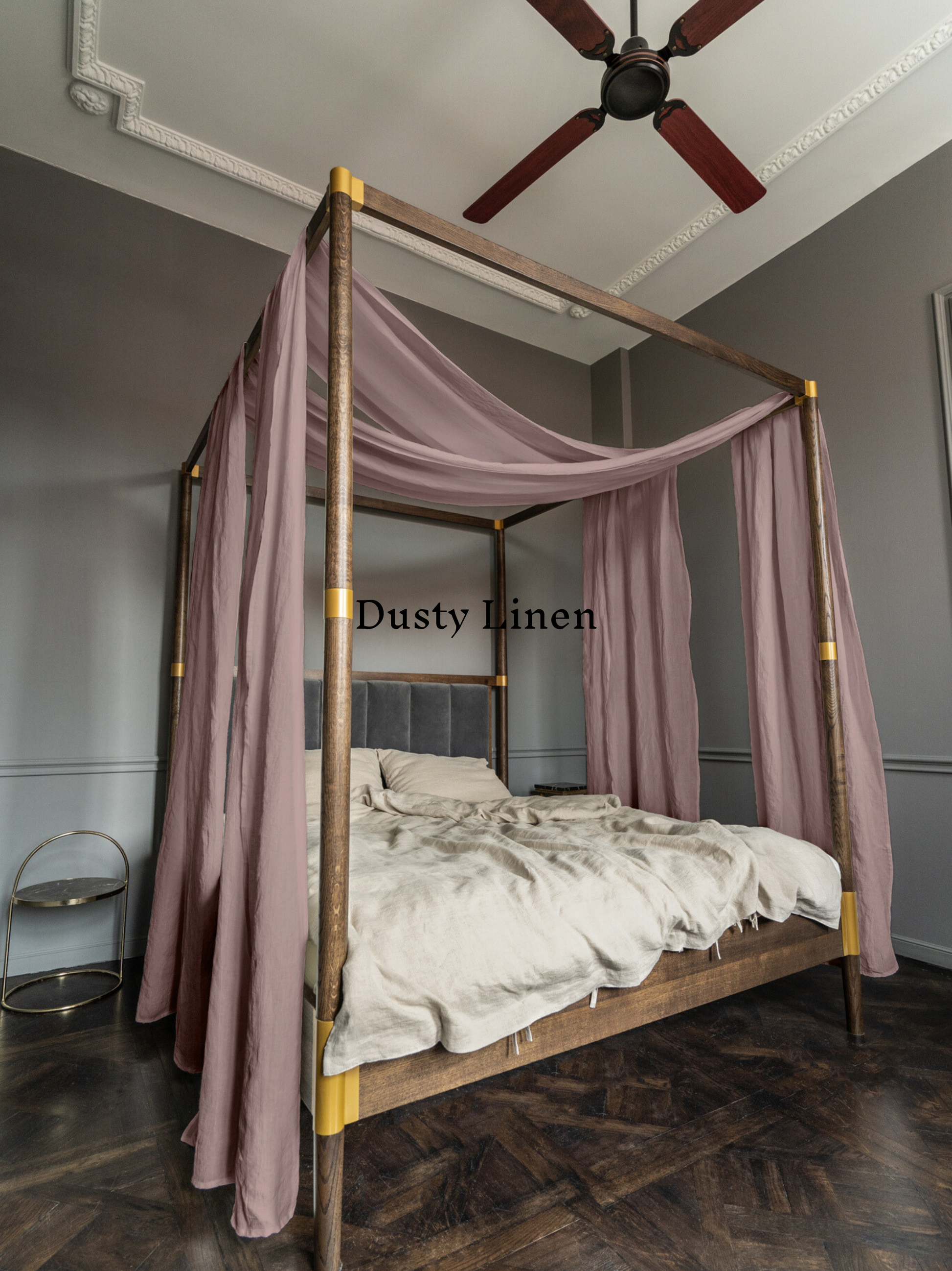 a four poster bed with a pink canopy