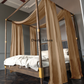 a four poster bed with a canopy and curtains