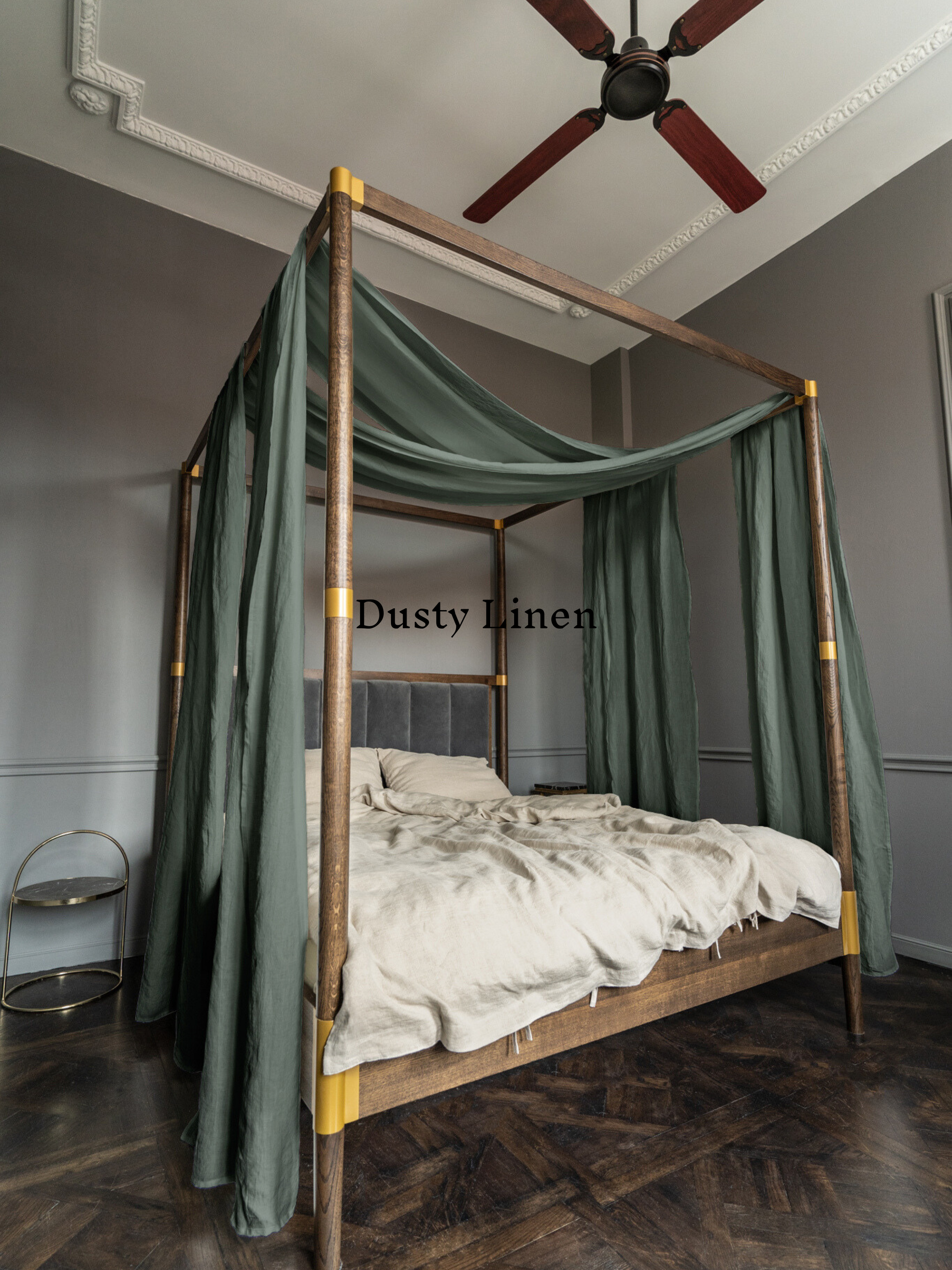 a four poster bed with a green canopy