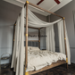 a four poster bed with a white canopy