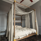 a four poster bed with a white canopy