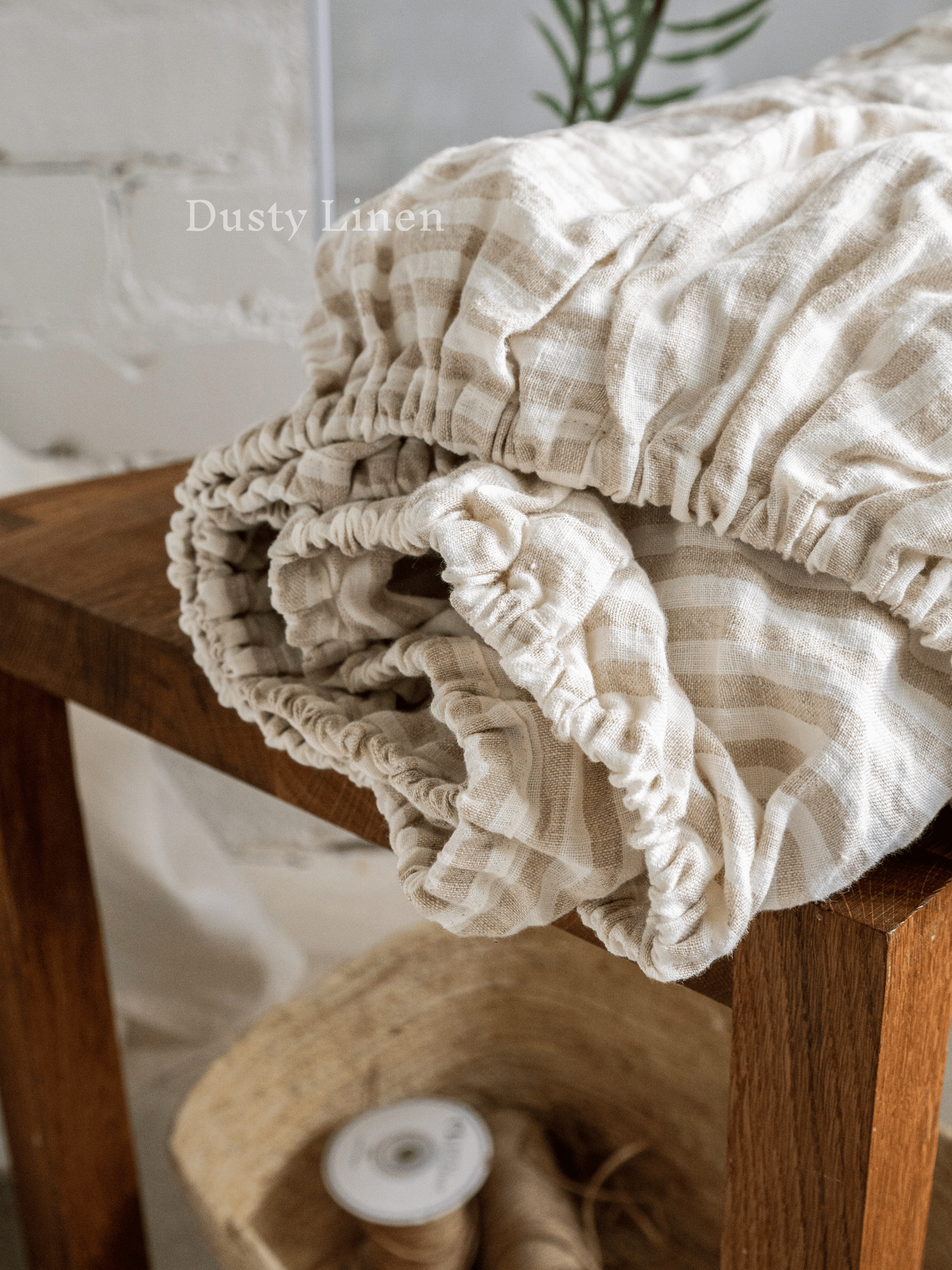 a wooden bench with a blanket on top of it