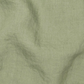 a close up of a green cloth with a black dot on it