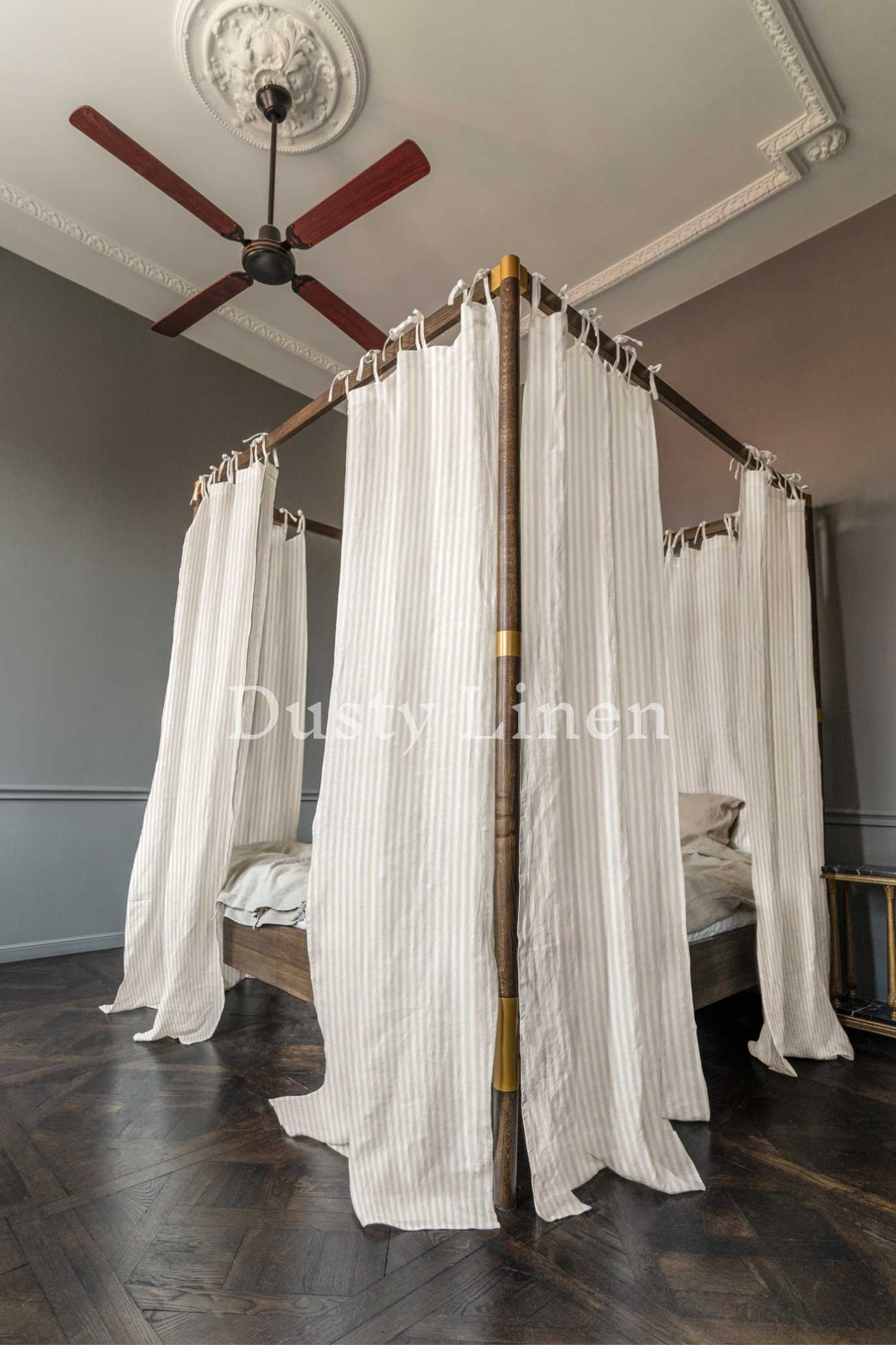 A bedroom with Striped Natural color canopy bed drapes with ties in boho style. Made by DustyLinen
