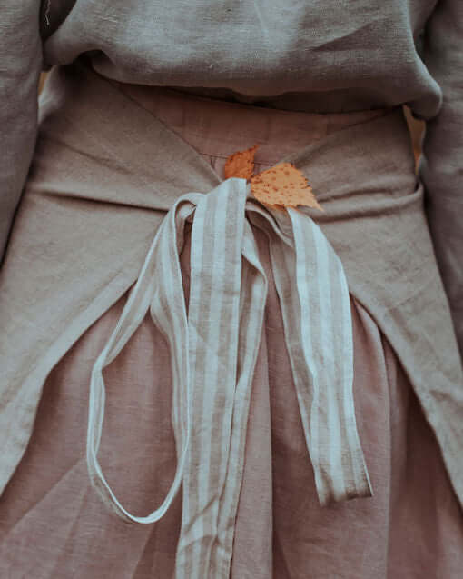 Linen half apron in dusty rose or warm tone, lifestyle photo