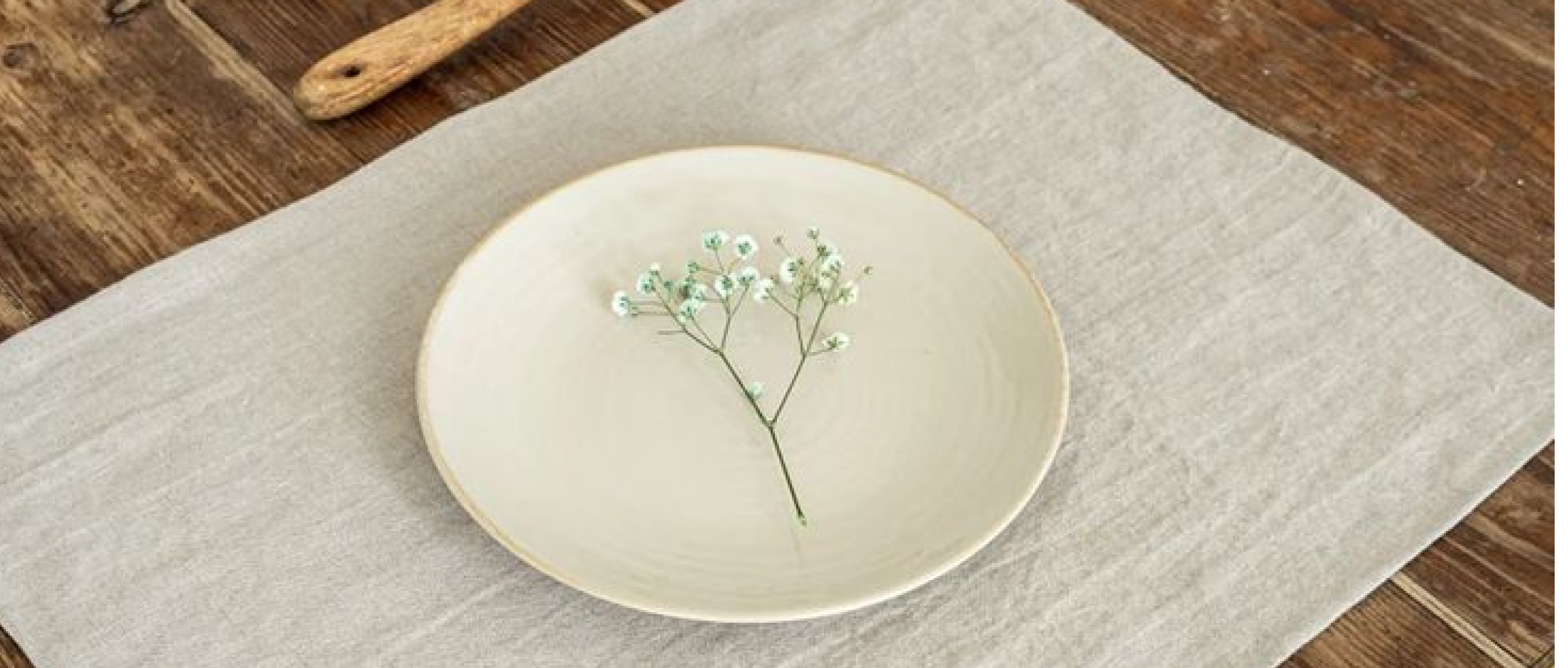 Natural linen placemat on a dining table in a minimalist table setting
