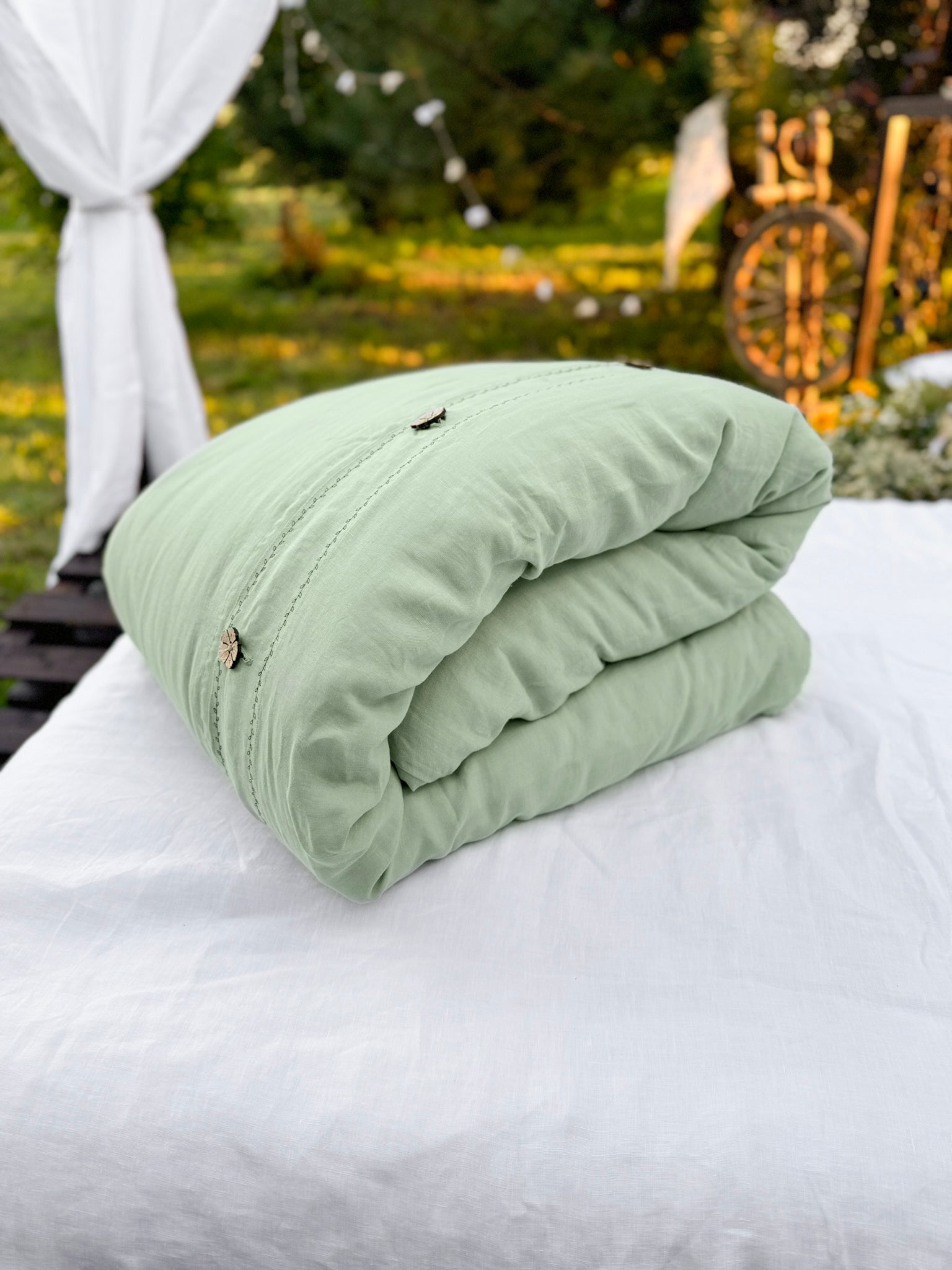 Black embroidered linen duvet cover styled on bed with matching pillowcases