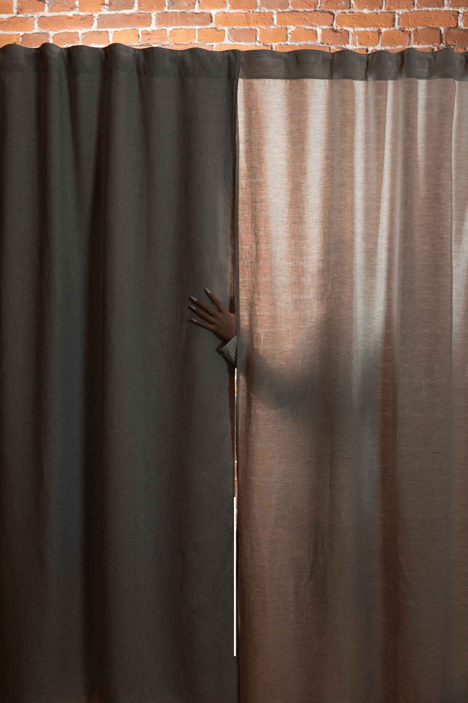 Close-up comparison of blackout and semi-sheer curtain fabrics on a window