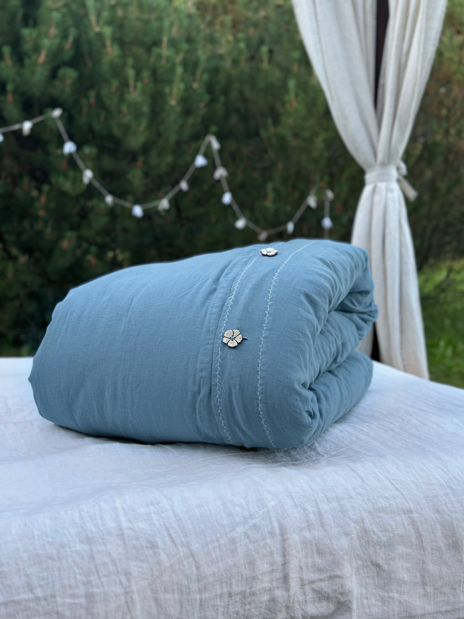 a blue pillow sitting on top of a white bed