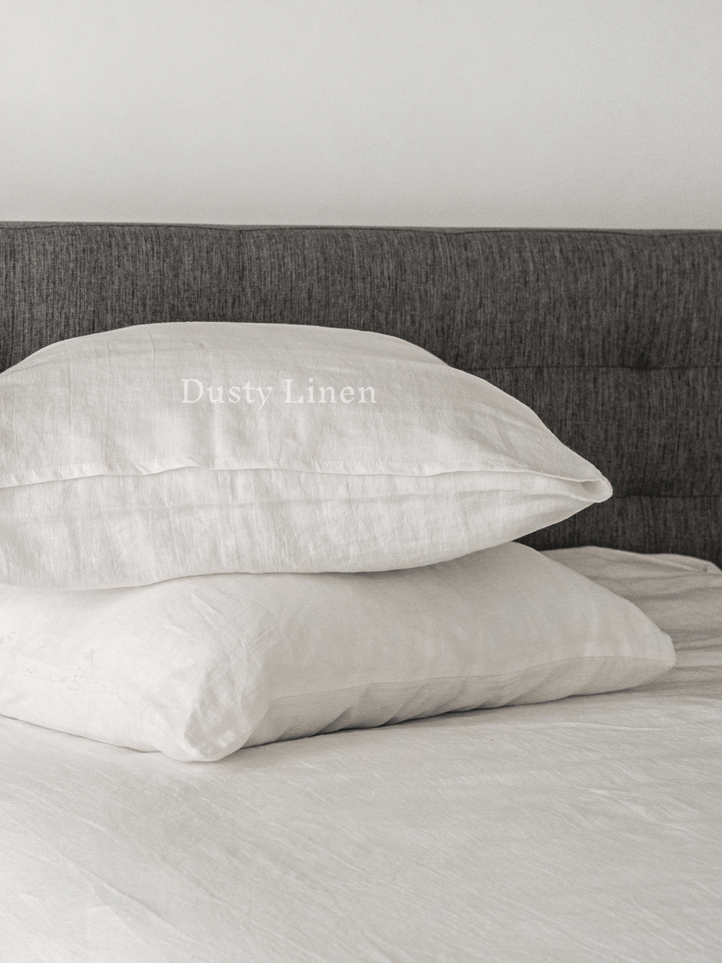 a close up of two pillows on a bed