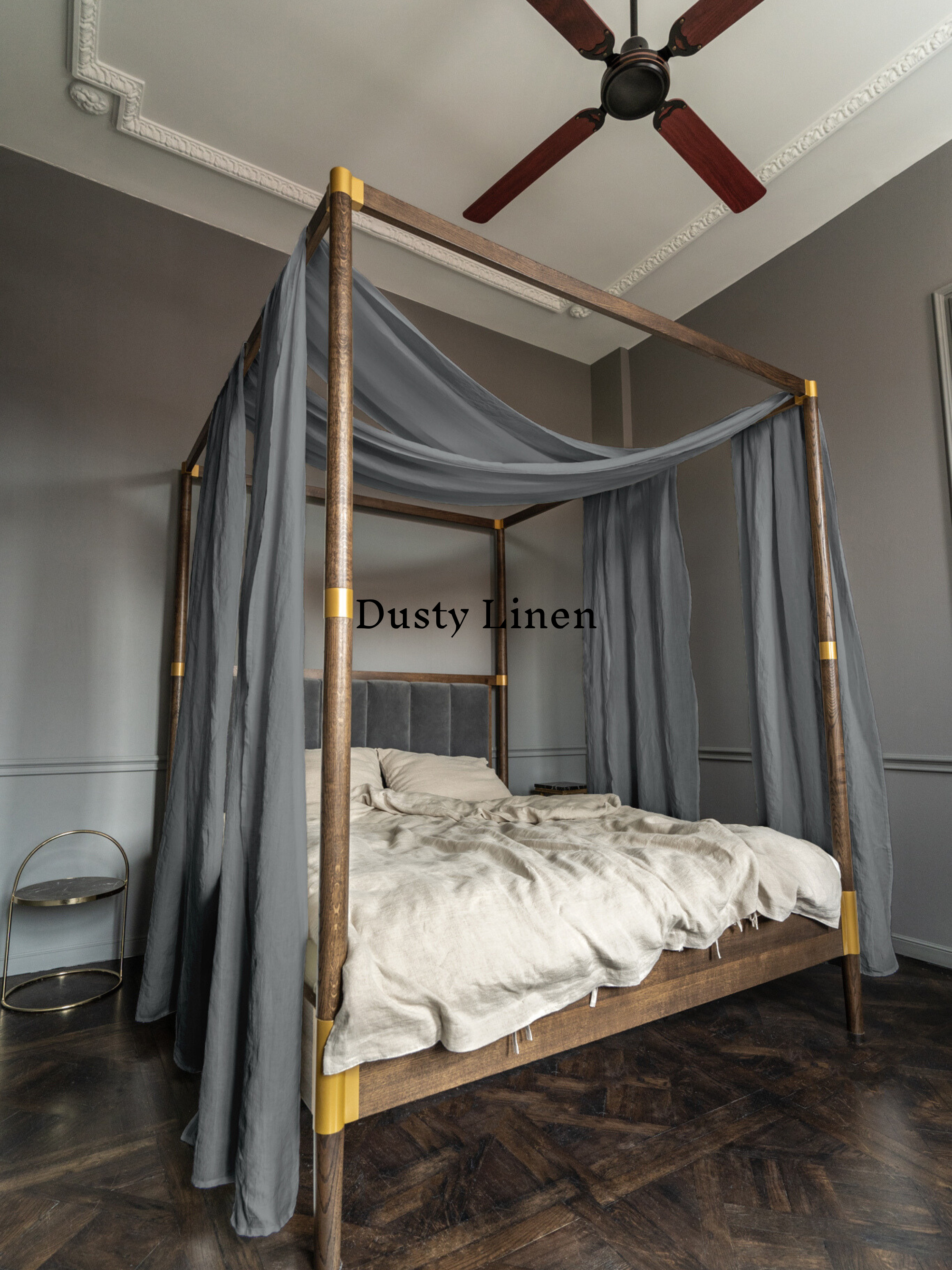 a bedroom with a four poster bed and a ceiling fan