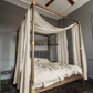 a four poster bed with a white canopy