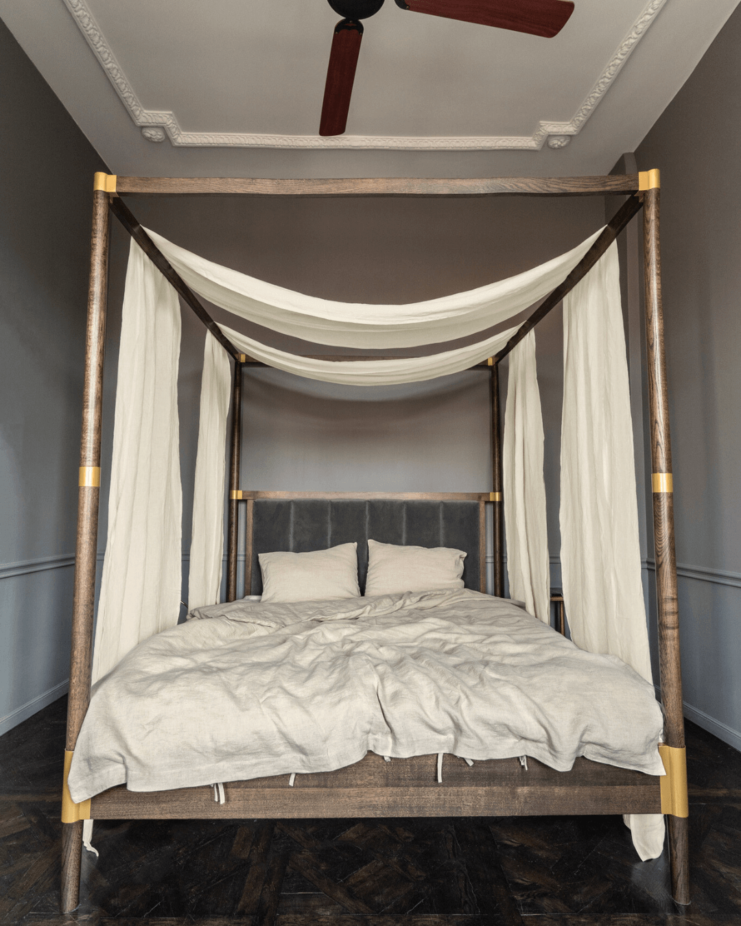 a bed with a white canopy and white pillows