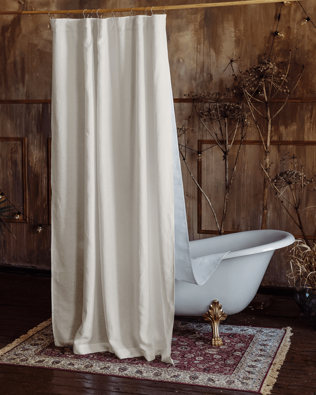 Cream linen shower curtain hung on rod in bathroom, full length view