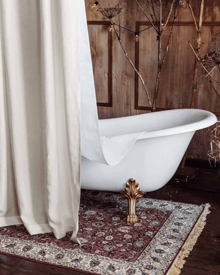 Close-up of cream linen shower curtain hook and rod attachment