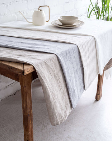 Linen tablecloth on dining table, natural tone, relaxed drape