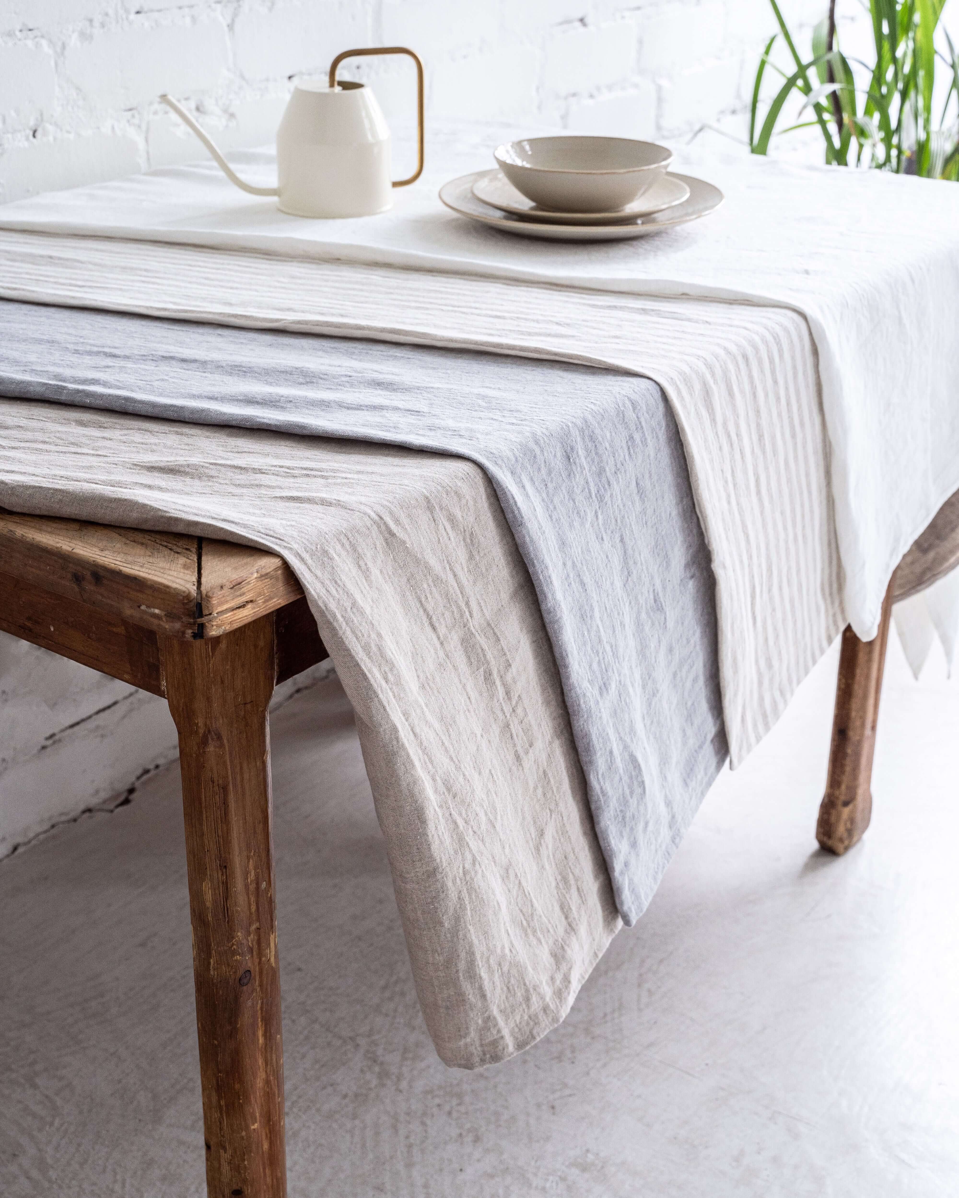 Linen tablecloth on dining table, natural tone, relaxed drape
