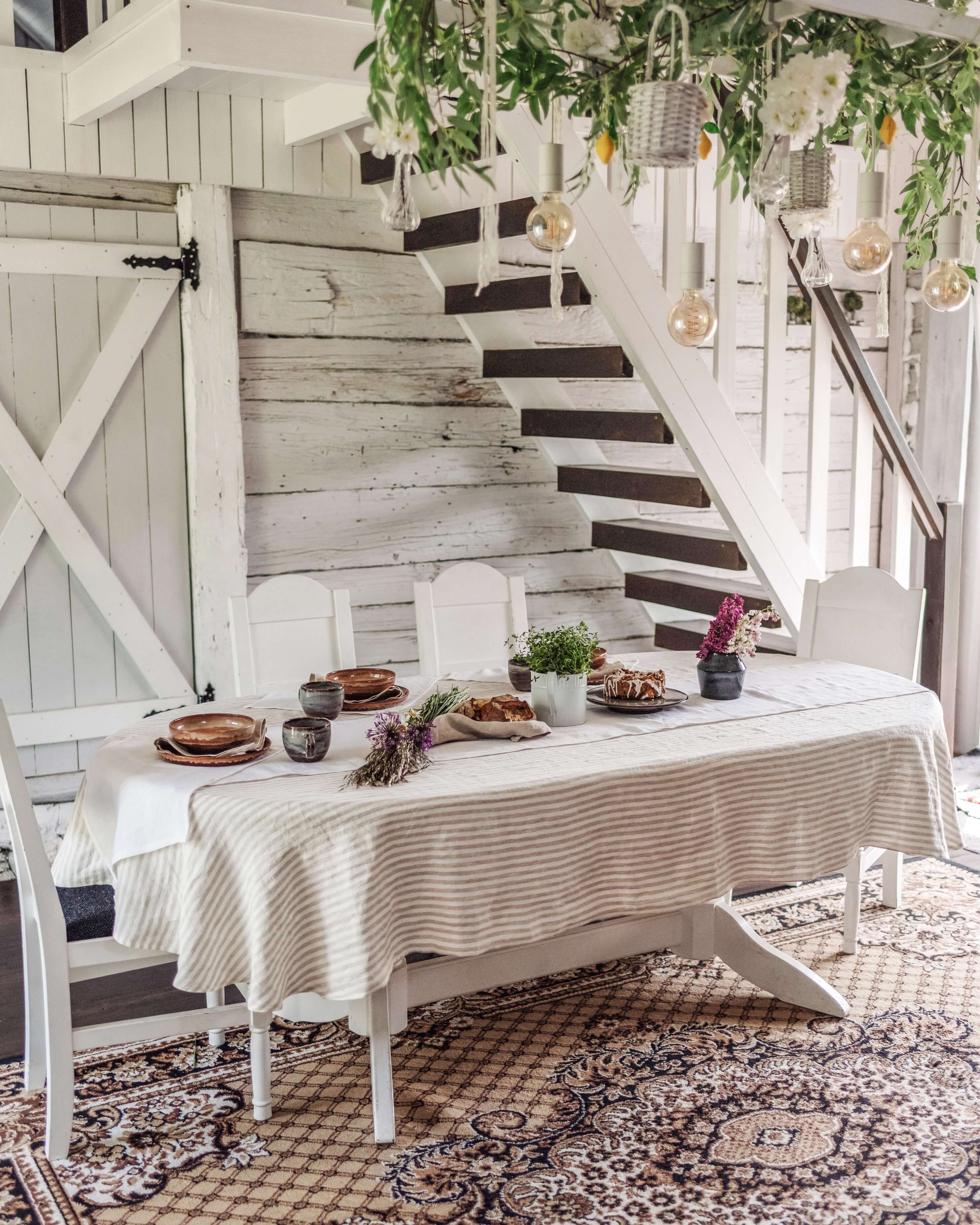 Oval linen tablecloth on table in dining room, side view showing drape