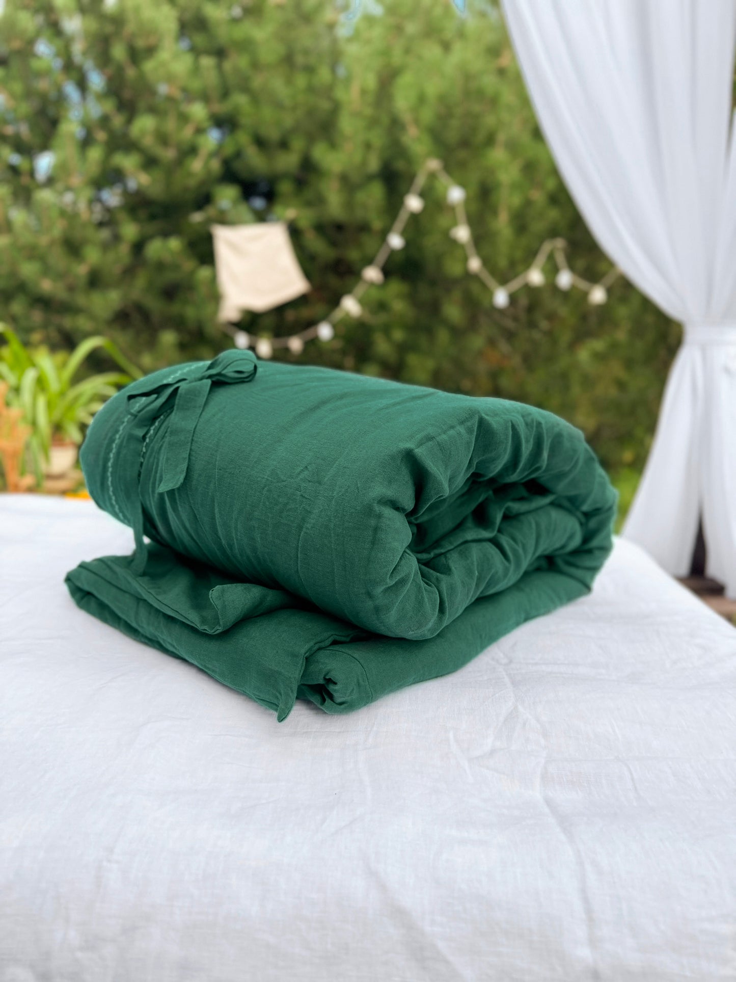 a bed with a green blanket on top of it