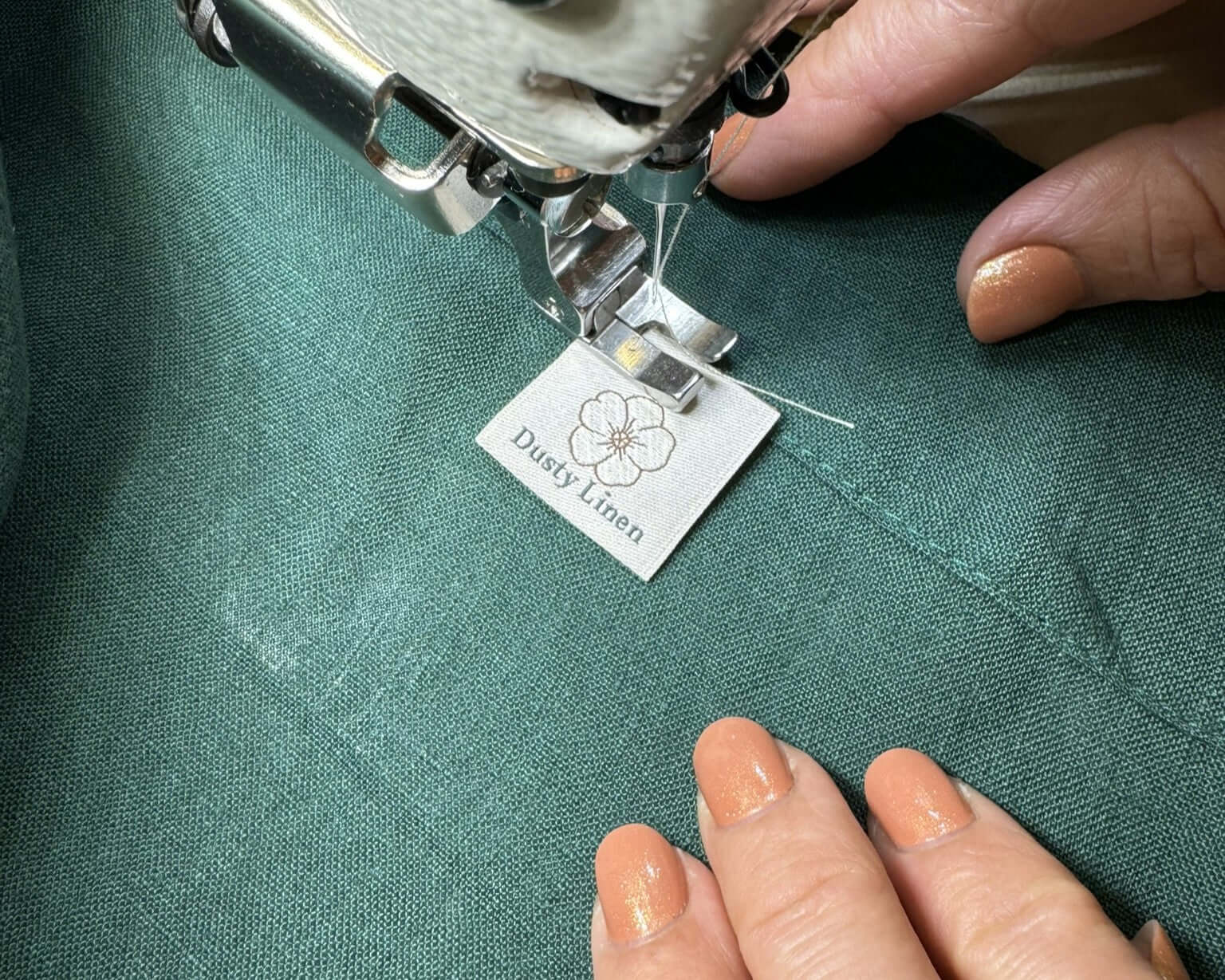 Dusty Linen label attached to green linen fabric