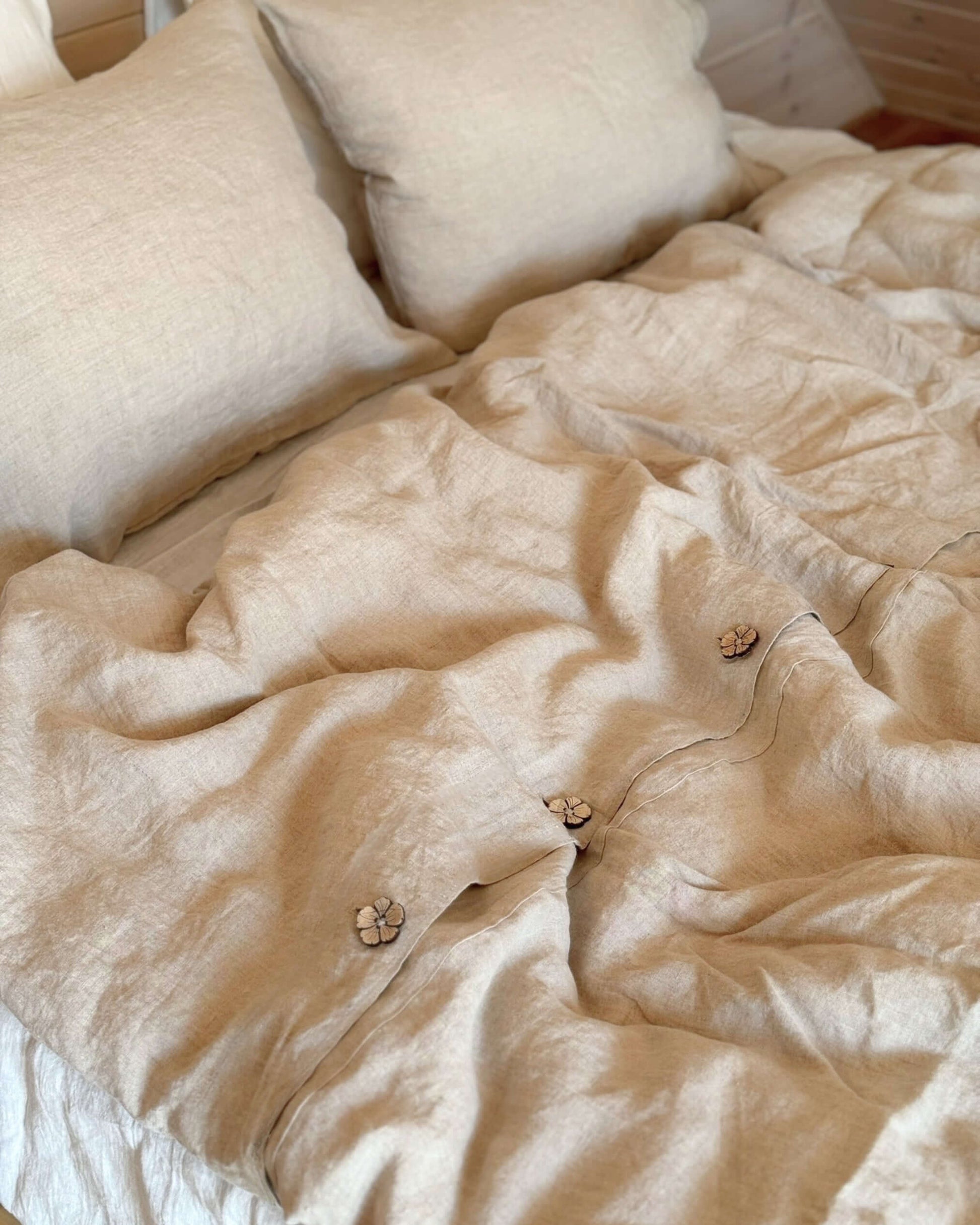 Minimalist linen duvet cover draped on bed, relaxed drape and natural texture