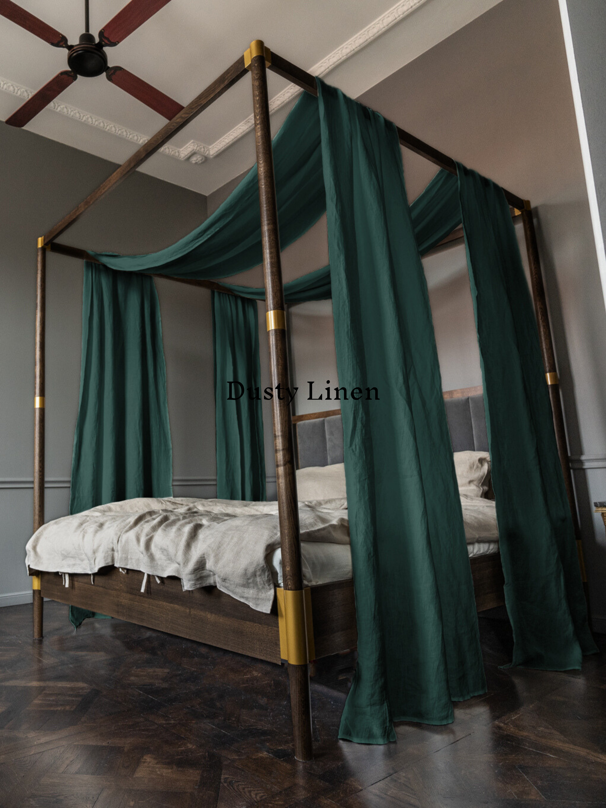 a canopy bed with a green drapes on top of it