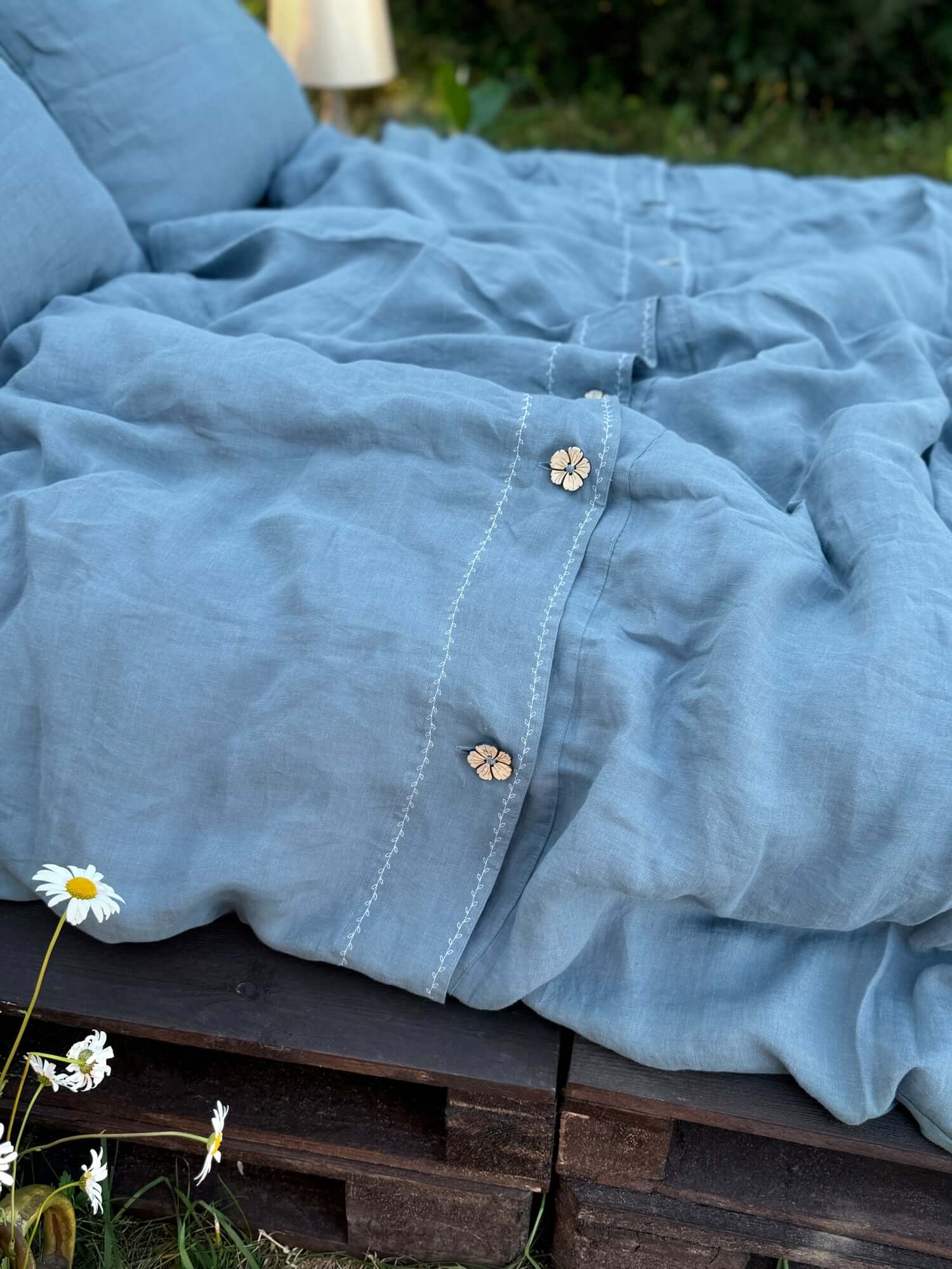 White embroidered linen duvet cover close-up, embroidery and linen texture